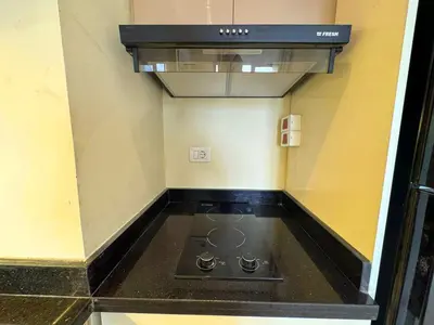 a kitchen with a stove top oven in a room at Beauty Aldau heights in Hurghada