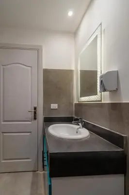 a bathroom with a sink and a mirror at Al Saraya Sahl Hasheesh by Peaks One Bedroom Apartment With Pool View C304 in Hurghada