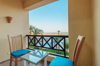 a room with a balcony with a table and chairs at Al Saraya Sahl Hasheesh by Peaks One Bedroom Apartment With Pool View C304 in Hurghada