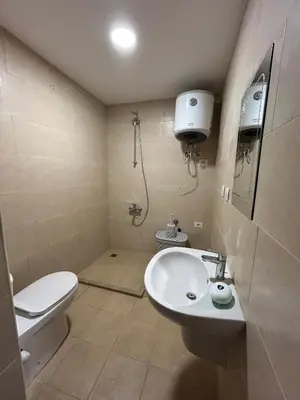 a bathroom with a white sink and a toilet at 1-Bedroom Aldau Heights in Hurghada