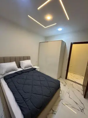 a bedroom with a bed in a room with marble floors at Two Bedroom Apartment in Hurghada