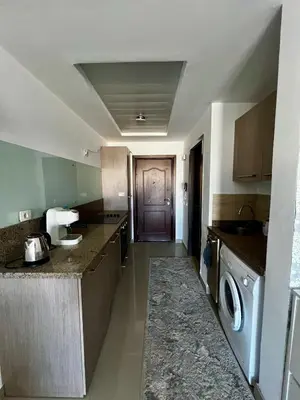 a large kitchen with a washer and dryer in it at Luxury Studio in Aldau Heights Hurghada in Hurghada