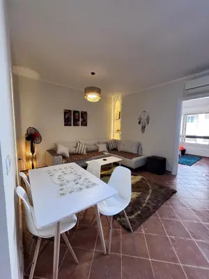 a living room with a white table and chairs at استديو قمريه in Hurghada