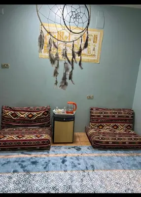 a room with two benches and a chandelier at Centre point Aswan in Aswan