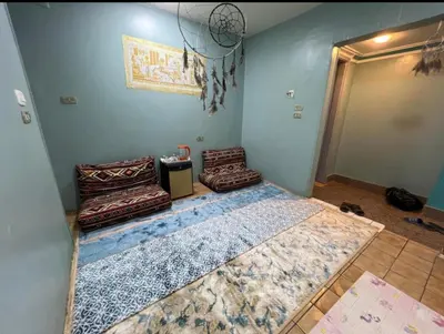a room with a large bed and two chairs at Centre point Aswan in Aswan