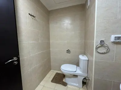 a bathroom with a toilet and a shower stall at Sun & Fun Aldau Heights one bedroom apartment in hurghada in Hurghada