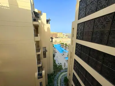 a view from a balcony of a building with a pool at Aldau Heights one bedroom apartment in Hurghada cr in Hurghada