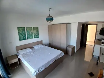 a bedroom with a bed and a pendant light at Gcribs B7F7 in El Gouna