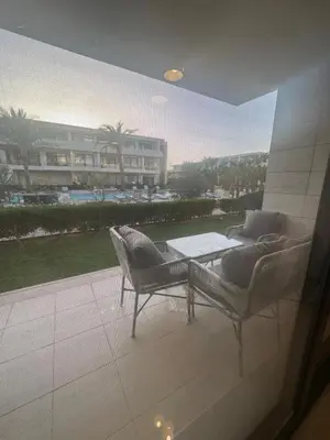 a view of a patio with a table and chairs at Hotel apartment in G cribs 2BR in El Gouna