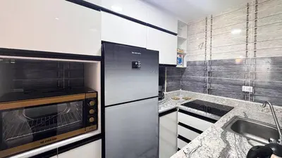 a kitchen with a stainless steel refrigerator and a sink at 2 bedrooms in Hurghada Hub Resort in Hurghada