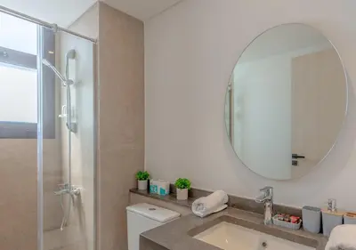 a bathroom with a sink and a mirror at Brand-New 1BR in Kamaran El Gouna I Pool View & Access in Hurghada