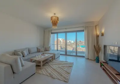 a living room with a couch and a table at Brand-New 1BR in Kamaran El Gouna I Pool View & Access in Hurghada