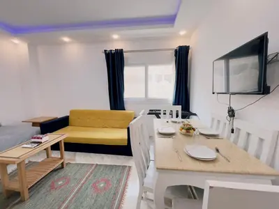 a living room with a table and a dining room at selena bay resort in El Gouna