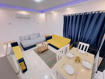 a small living room with a couch and a table at selena bay resort in El Gouna