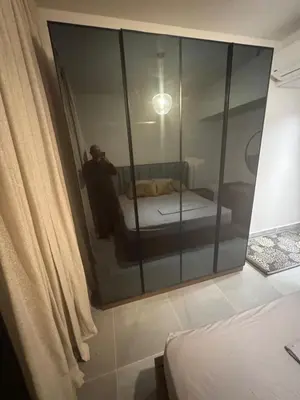 a person taking a picture of a bedroom with a mirror at Luxury 3BD Makadi Heights phase 2 Orascom in Hurghada