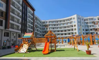 a playground with a slide and a swing set at Taiba Golden Resort in Hurghada