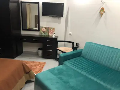 a living room with a blue couch and a mirror at scandic Resort hurghada in Hurghada