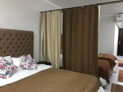a bedroom with two beds and a large window at scandic Resort hurghada in Hurghada