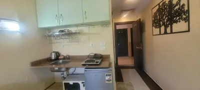 a small kitchen with a counter and a sink at Beachfront Resort Seaview Haven Modern Near Airport in Hurghada