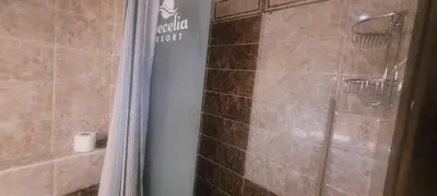 a bathroom with a shower with a shower curtain at Beachfront Resort Seaview Haven Modern Near Airport in Hurghada