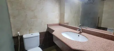 a bathroom with a sink and a toilet and a mirror at Apartment With Free Private Beach Furnished Near senzomall in Hurghada
