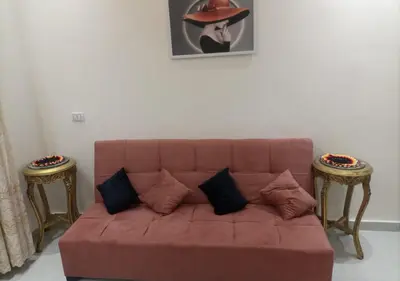 a red couch with pillows in a living room at -Hurghada HUB Resort-Peaceful Getaway in Hurghada