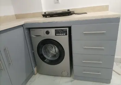 a washing machine under a counter in a kitchen at Fanadir Bay - beach & Aquapark in Hurghada