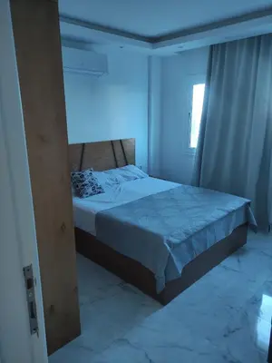 a bedroom with a bed with a blue light at Hurghada Fanader bay in Hurghada