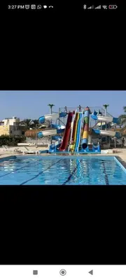 a swimming pool with a water slide in a resort at Hurghada Fanader bay in Hurghada