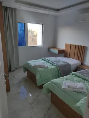 a bedroom with two beds and a window at Hurghada Fanader bay in Hurghada