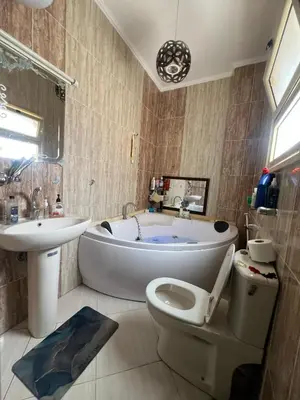 a bathroom with a tub and a toilet and a sink at Sunflower cozy apartment in Hurghada