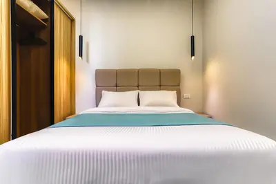 a bedroom with a large bed with white sheets at La Prestigia luxury Apartments by Peaks in Hurghada