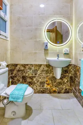 a bathroom with a toilet and a sink at La Prestigia luxury Apartments by Peaks in Hurghada