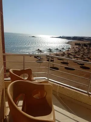 a balcony with a view of the beach and a toilet at Casablanca beach in Hurghada