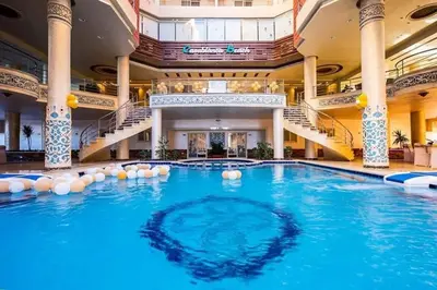 a large swimming pool in a building with stairs at Casablanca beach in Hurghada