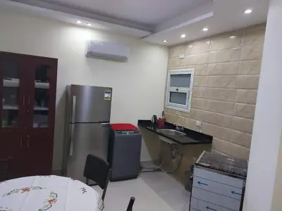 a kitchen with a stainless steel refrigerator and a desk at Casablanca beach in Hurghada