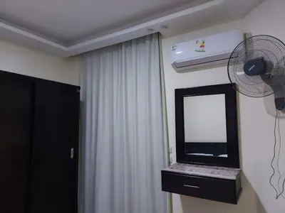 a room with a white curtain and a fan at Casablanca beach in Hurghada