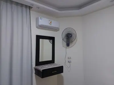 a bathroom with a mirror and a fan at Casablanca beach in Hurghada
