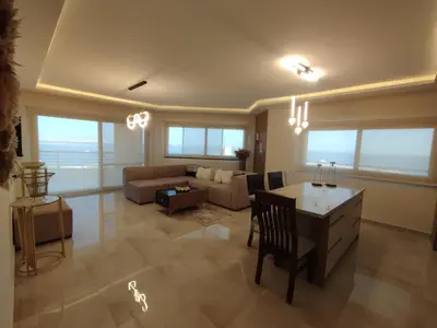 a living room with a couch and a table at The View Island in Hurghada