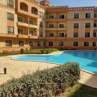 a large apartment building with a large swimming pool at red ruby Comfort in Hurghada