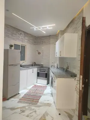 a kitchen with white cabinets and a white refrigerator at red ruby Comfort in Hurghada