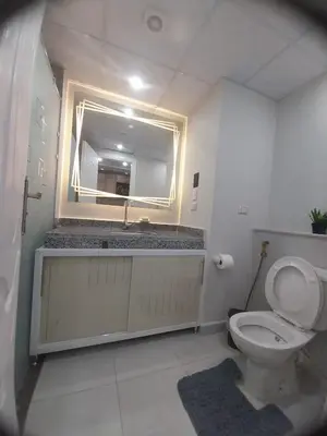 a bathroom with a sink and a toilet and a mirror at pola studio at scandic resort in Hurghada