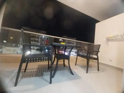 a black table and two chairs in a room at pola studio at scandic resort in Hurghada