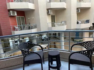 a balcony with two chairs and a table on a building at Studio in Hurghada