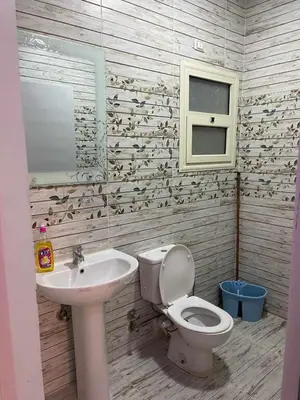 a bathroom with a toilet and a sink at Studio in Hurghada