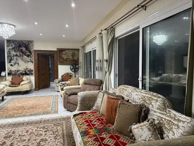 a living room with couches and a large window at Villa 348 Jamaran - Sahl Hasheesh in Hurghada