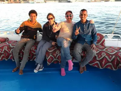 a group of people sitting on the back of a boat at valleyofthenileadventures in Luxor