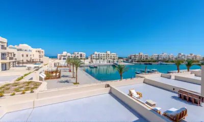 a view of the pool at a resort with palm trees at Luxury Stays in Fanadir Marina El Gouna in Hurghada