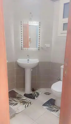 a bathroom with a sink and a toilet at Princess Resort 109 B Al Mamsha Al Seyahi in Hurghada