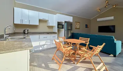 a kitchen with a table and chairs and a couch at Bali 2 BR private pool el gouna heated pool in Hurghada